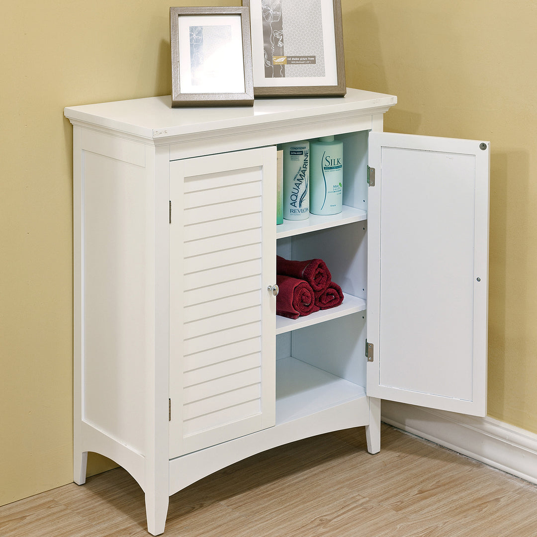 A two-door white floor cabinet with an open door