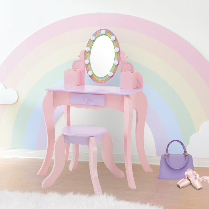 Fantasy Fields Little Princess Rapunzel Vanity with LED Illuminated Mirror against a rainbow wall 