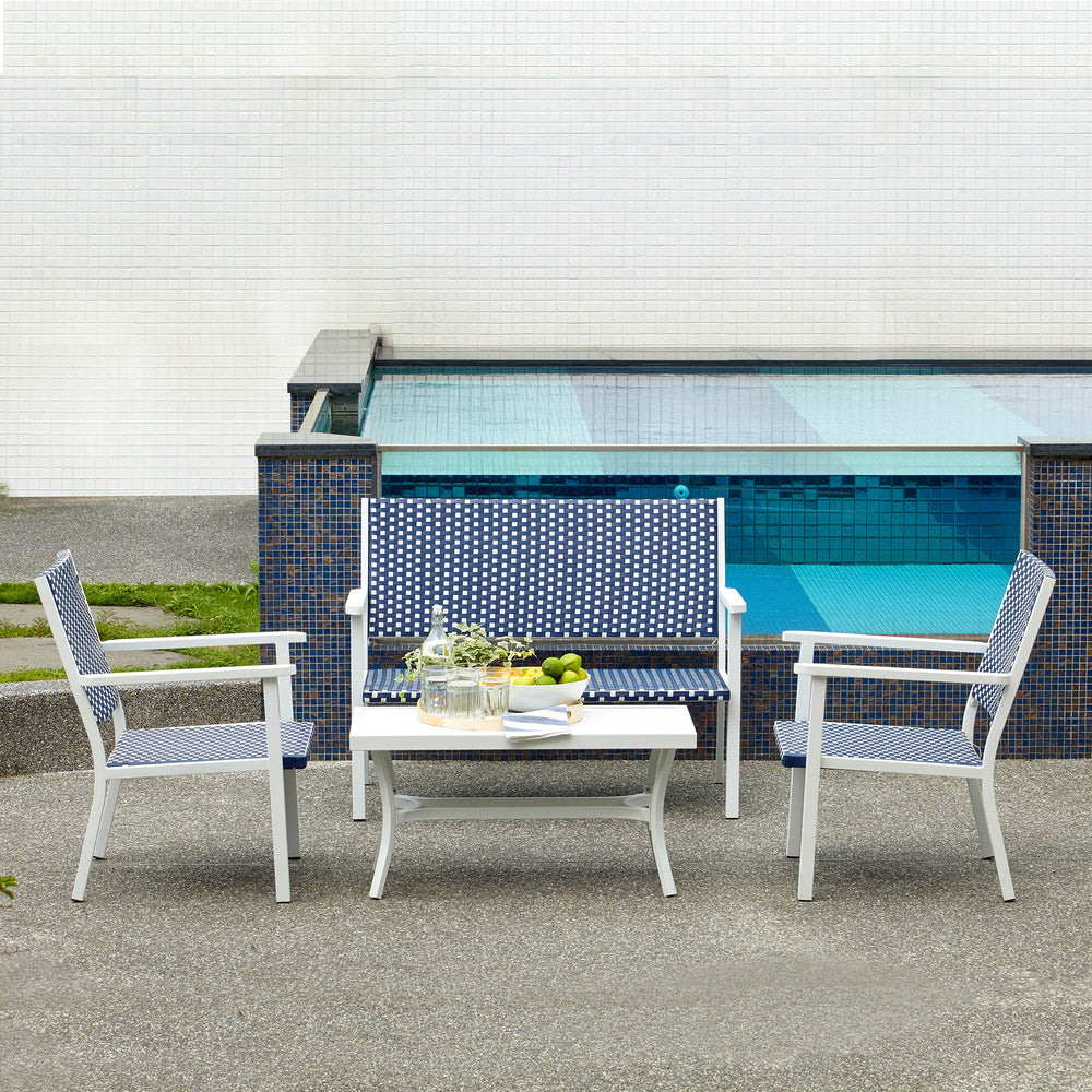 Teamson Home Outdoor Blue & White PE Rattan 4-Piece Patio Set with two chairs, a love seat, and coffee table by a swimming pool.