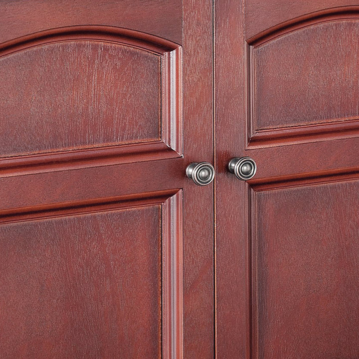 A close-up of a pair of round antiqued brass pull knobs