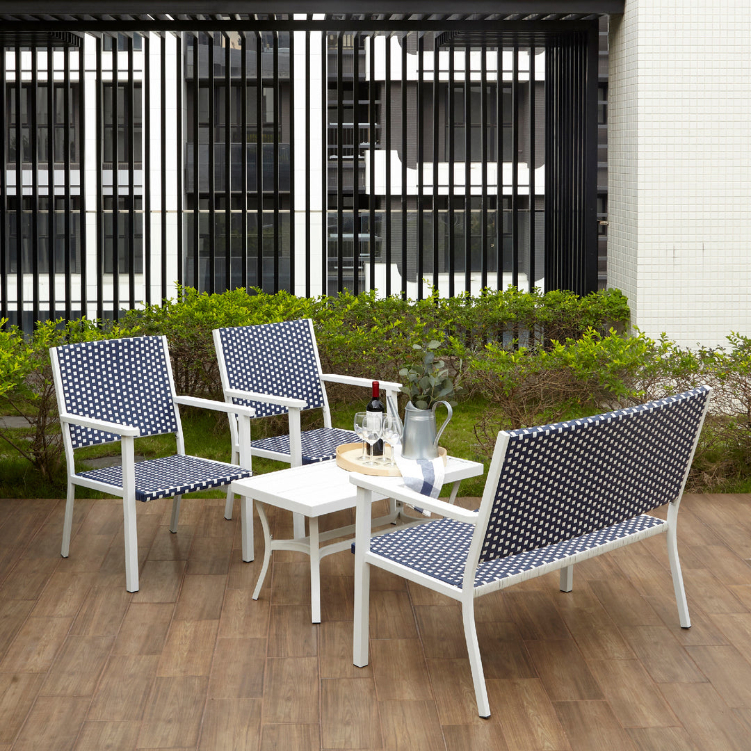Teamson Home Outdoor Blue & White PE Rattan 4-Piece Patio Set with two chairs, a love seat, and coffee table on a terrace